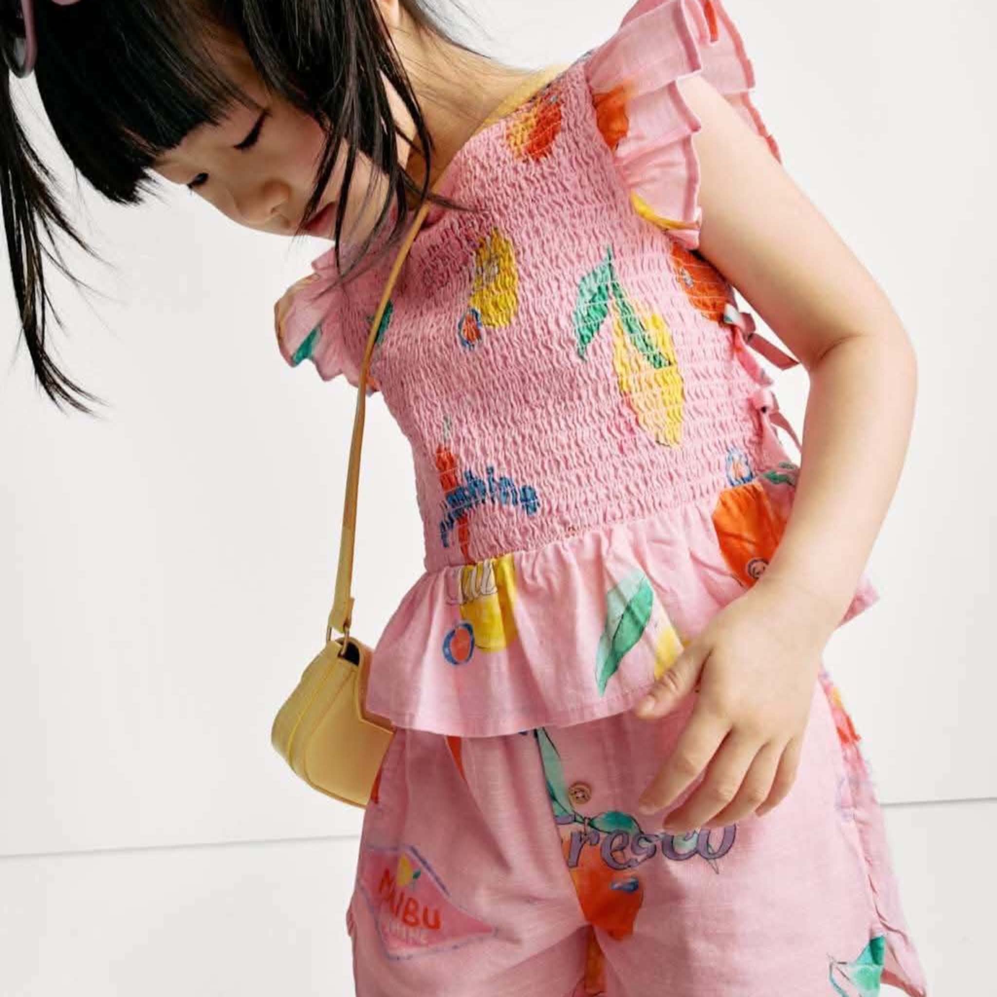 Happy child jumping in a colourful LittleBebe dress